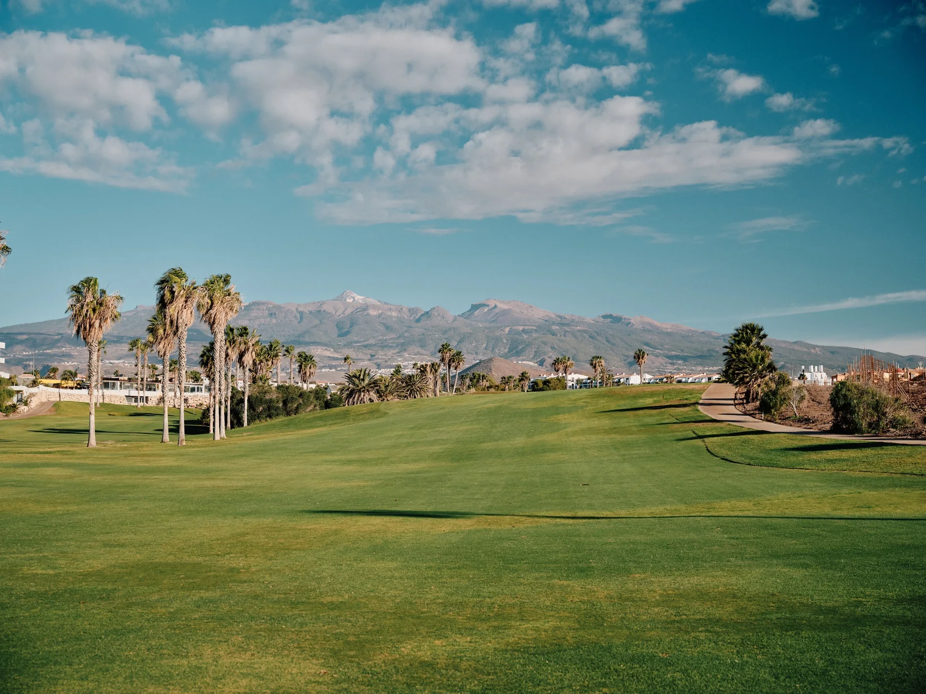 Wide championship fairway at Amarilla Golf with Tenerife's mountains in the distance